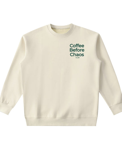 Tuvi Coffee Before Chaos crewneck sweatshirt in cream with dark green chest text in a relaxed fit.
