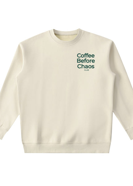 Tuvi Coffee Before Chaos crewneck sweatshirt in cream with dark green chest text in a relaxed fit.