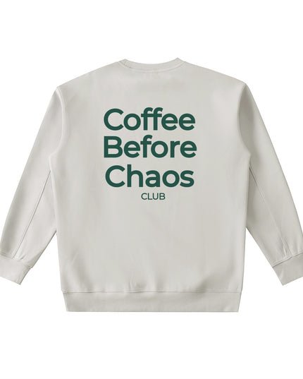 Tuvi Coffee Before Chaos crewneck sweatshirt in beige with dark green text on the back.
